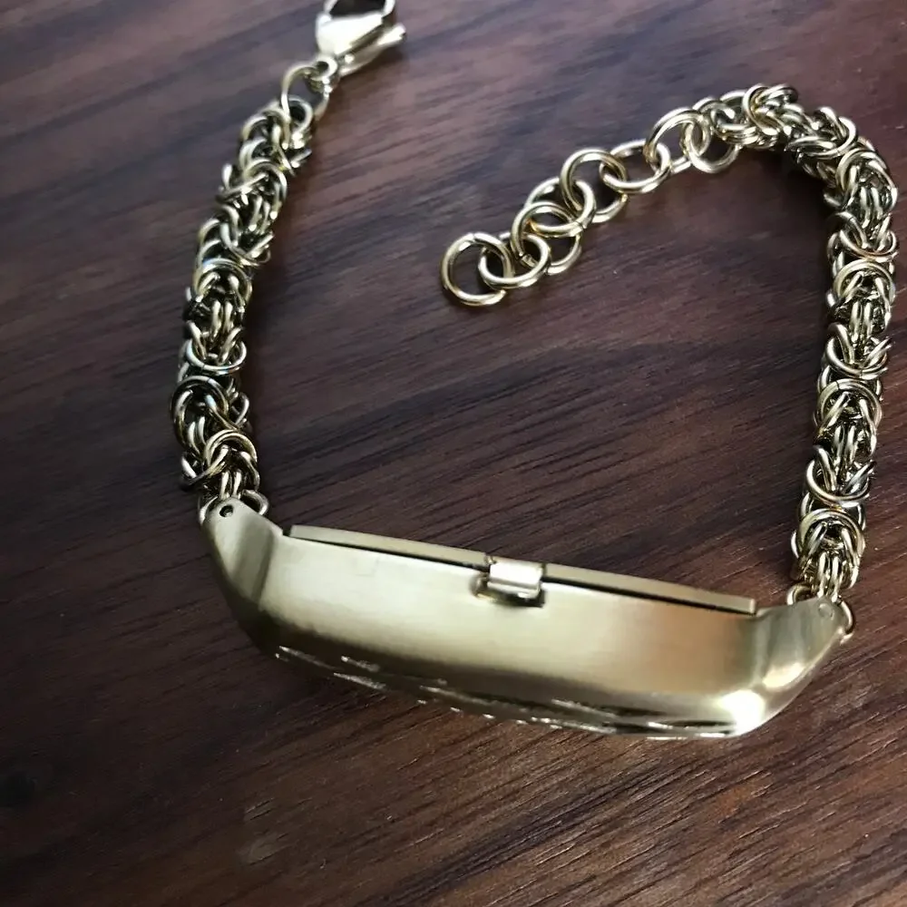 Brushed gold tone bracelet w/ a compartment for a fitbit device